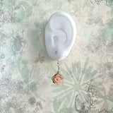 Peach wood crafted chinese lucky cloud 925 silver ear wire drop earrings is an aroma diffuser on-the-go, displays on an ear model
