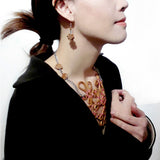 Delicate 925 silver ear wire dangle earrings features a mini scale  peach wood crafted traditional chinese lucky knot wear by an asian female model 