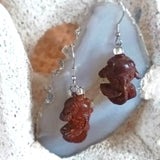 Close-up on pair of 925 silver ear wire dangle earrings features red sandal wood crafted vivid mini chinese gold fish and glass bead.

 