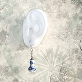 925 silver dangle earring features oriental blue and white ceramic vase with simple bamboo hand drawing, display on a white ear form

