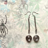 Pair of interesting silver dangle earring carry a detailly made doll size frying pan showing the back side 