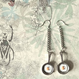 Pair of cute 925 silver ear wire dangle earrings elongated by refined metal chain, features detailly made mini size frying pan with an egg on top.