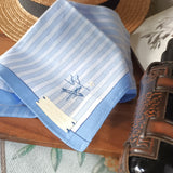 Exquisite blue and white hanky with blue border has a hand stitched Zen style line art motif at the corner
