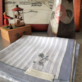 Exquisite cotton handkerchief in light grey symmetrical stripes, has a mini vase-and-plant motif hand embroidery near the corner.