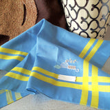 Delicate blue cotton hanky with two yellow stripes as border, hand stitched a detailed motif of table setting for night supper