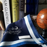 A classy dark navy pure cotton handkerchief decorated by white linear lines along the border and hand-embroidered a line drawing scenery of fishmen fixing fishing net under the crescent moon