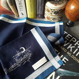 A classy dark navy pure cotton handkerchief decorated by white linear lines along the border and hand-embroidered a line drawing scenery of fishmen fixing fishing net under the crescent moon 