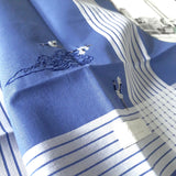 Close-up of blue cotton handkerchief and multi stripes border, delicately hand embroidered three white storks and cloud in oriental style
