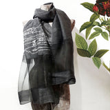 Sheer black color silk wool scarf has a  big embroidery of line art landscape scenery detailed by ancient Chinese house, trees, cow and power towers on the hills