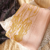 Sheer and light weight soft salmon color silk wool scarf has a big gold yellow embroidery of natural landscape scenery compose of old chinese huts, low bush and streams