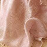 Close up of sheer salmon color scarf hand embroidered a bunch of  magnolia flower with elf swinging,  in line art style.