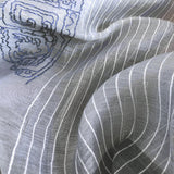 Close up of light grey silk wool scarf features white pin-stripes and a big hand embroidery of blueline art of traditional chinese bucket arch and ornaments. 