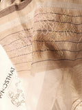 Close-up of the hand embroidered big multi-color flower line drawing, on the  beige color silk wool scarf highlighted by brown pin-stripes and a wide organza on the hem. 