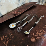Three adorable 925 silver ear wire earrings with tiny metal chain elongation, in three styles of detailed mini scale egg frying saucepan, egg whisk and soup ladle 