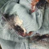 Pale blue two-tone weave linen shawl, hand-stitched a few swirl-like line art  patterns and red-black-white color hand felted wool sea islands pattern.