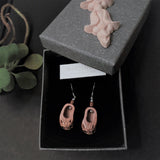 A pair of 925 silver ear wire dangle earrings features delicate peach wood crafted Chinese traditional baby shoes with symbolic lion head displayed in an original design grey paper box decorated by a wood craft ornament on top