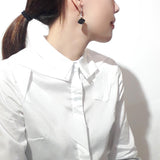 925 sterling silver dangle earring featured by black sandalwood crafted chinese auspicious cloud form, wear by a chinese young lady in white fashion shirt