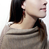 925 sterling silver dangle earring featured by a hanging red sandalwood crafted goldfish, wear by a chinese young lady in slouchy wool top