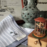 A grey and white striped pure cotton handkerchief with a small hand embroidery of vase and falling petals