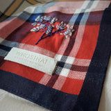 Red and black plaid handkerchief hand embroidered a small pattern of blossom tree at the corner