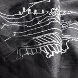Close up of light weight black silk wool scarf has embroidered a big white line art landscape pattern combine of ancient Chinese village and  power towers on the hills